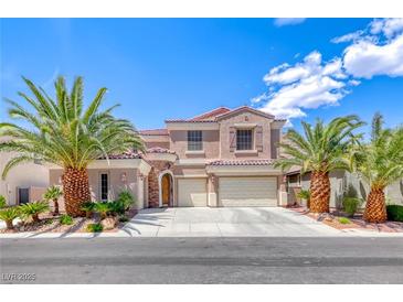 Charming stucco home with tile roof, three-car garage, and lush landscaping featuring mature palm trees at 11275 Gammila Dr, Las Vegas, NV 89141