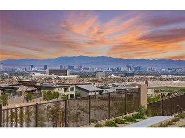 Scenic aerial view showcases the city skyline, mountains, and desert landscape beyond modern home at 12648 Heritage Bend Dr, Las Vegas, NV 89138