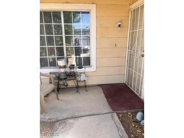 Inviting front porch with seating, a security door, and a large window, creating a warm welcome to the home at 1676 Divinity St, Las Vegas, NV 89142