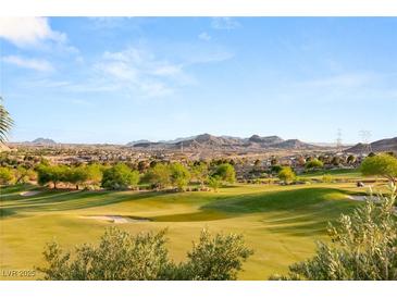 Scenic view of lush golf course with mature trees and mountain views at 21 Avenida Sorrento, Henderson, NV 89011