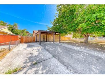 Charming single-story home featuring a spacious front yard with mature trees and covered parking at 4100 Montebello Ave, Las Vegas, NV 89110
