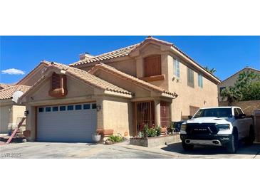 Charming two-story home with a well-maintained front yard and a visible two-car garage, and white truck at 6429 Rosemount Ave, Las Vegas, NV 89156