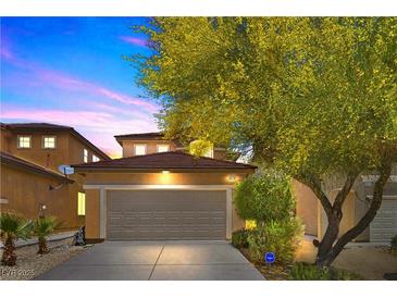Charming two-story home with a well-maintained front yard and a two-car garage showcasing a suburban feel at 9218 Grassy Weep Ct, Las Vegas, NV 89178