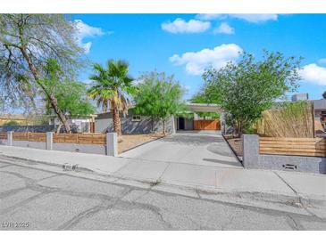 Charming single-story home with a landscaped front yard, driveway, and modern fence at 942 Westminster Ave, Las Vegas, NV 89119