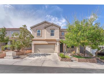 Charming two-story home showcasing manicured landscaping, neutral colors, and an attached two-car garage at 10432 Britton Hill Ave, Las Vegas, NV 89129