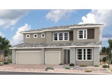 Contemporary two-story home featuring stone accents, a three-car garage, and a meticulously landscaped front yard at 1160 Viento View Ave, Henderson, NV 89012