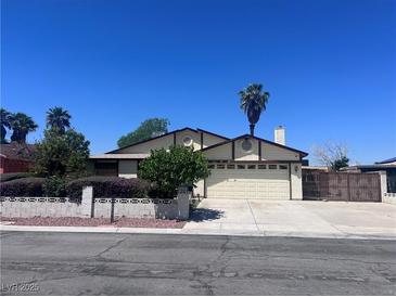 Charming single-story home featuring a well-maintained lawn and desert landscaping, with a two-car garage at 1281 Challenge Ln, Las Vegas, NV 89110