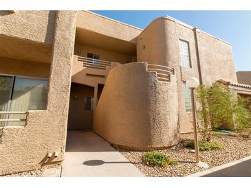 Attractive condo building showcasing the exterior with stucco and desert landscaping at 2191 Bay Club Dr # 204, Laughlin, NV 89029