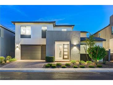 Contemporary two-story home showcasing sleek architecture and manicured landscaping at twilight at 4177 Railhead Pass Ave, Las Vegas, NV 89141