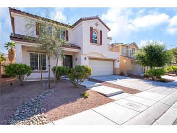 Charming two-story home with a well-manicured front yard and a two-car garage at 7098 Seabirds Pl, North Las Vegas, NV 89084