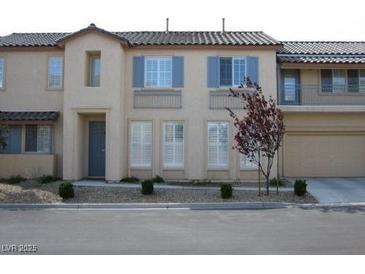 Inviting townhome featuring a neutral color palette, tidy landscaping, and a two-car garage at 8139 Retriever Ave, Las Vegas, NV 89147
