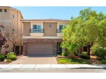 Charming two-story home featuring a brick-accented garage and balconies at 9823 Belle Marie Ct, Las Vegas, NV 89141
