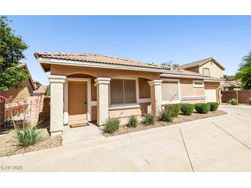 Charming single-story home featuring a tile roof, well-kept landscaping, and inviting front entrance at 1440 Summer Glow Ave, Henderson, NV 89012