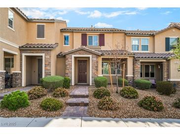 Charming townhome featuring a well-maintained landscaped front yard and inviting entryway at 2871 Tanager Hill St, Henderson, NV 89044