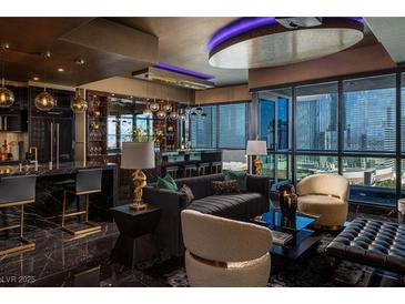 Modern living room with a city view, marble floors, and a stylish bar area, perfect for entertaining at 4575 Dean Martin Dr # 1909, Las Vegas, NV 89103
