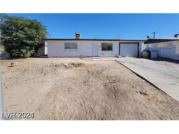 Single-story home with desert landscaping, driveway, and attached garage, showcasing curb appeal and potential at 4808 Everman Dr, Las Vegas, NV 89122
