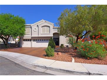 Charming two-story home featuring an attached three-car garage and well-maintained landscaping at 614 Ravenglen Dr, Las Vegas, NV 89123