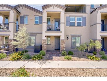 Charming townhome featuring a private balcony and well-maintained landscaping at 664 Foam Flower Ln, Henderson, NV 89015