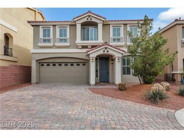 Charming home featuring manicured landscaping, a paved driveway, and a two-car garage at 8176 Duncan Peak Ct, Las Vegas, NV 89139