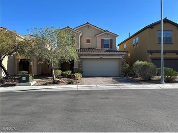 Charming two-story home featuring stucco siding, a tile roof, a two-car garage, and manicured landscaping at 8977 Melridge Rd, Las Vegas, NV 89148