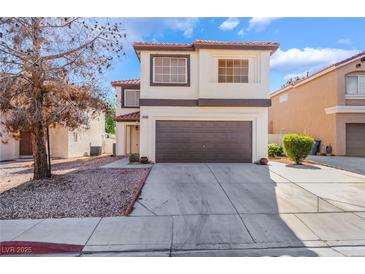 Charming two-story home with a well-maintained lawn and a spacious two-car garage at 10166 Monks Hood Ct, Las Vegas, NV 89183