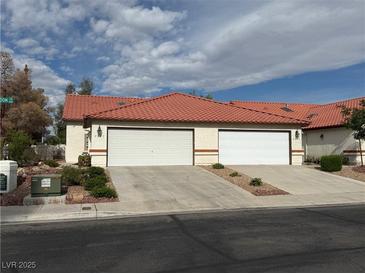 Charming single-story home featuring a red tile roof and attached two-car garage at 2679 Magic Moon Ln, Las Vegas, NV 89146