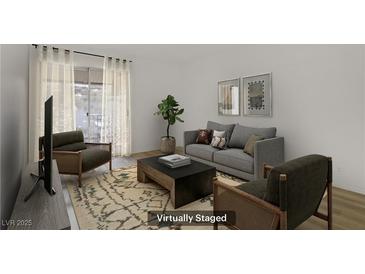 Staged living room features modern furniture, neutral tones, and ample natural light at 4310 Sandy River Dr # 70, Las Vegas, NV 89103