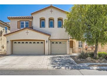 Charming two-story home with a three-car garage, stucco facade, and well-maintained landscaping at 5920 Big Horn View St, North Las Vegas, NV 89031