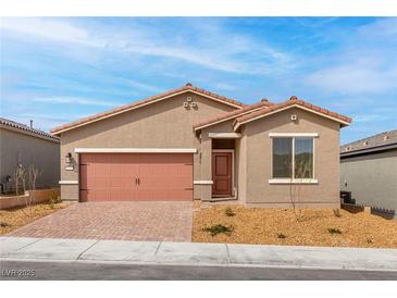Inviting single-story home featuring a two-car garage, desert landscaping, and a neutral color palette at 6737 Lotus Vista Ct, Las Vegas, NV 89156