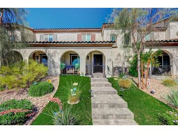 Charming townhome with arched entryways, well-manicured landscaping and a welcoming entrance at 759 Pickled Pepper Pl, Henderson, NV 89011