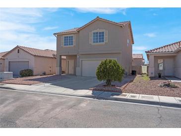 Two story home with desert landscaping and a two car garage under a blue sky at 8725 Russet Hills Ct, Las Vegas, NV 89147