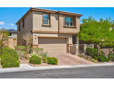 Charming two-story home featuring a paved driveway, attached two-car garage, and well-manicured front yard at 880 Cirrus Cloud Ave, Las Vegas, NV 89138
