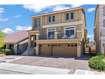 Two-story home showcasing a private balcony, two-car garage, and tiled roof at 9742 Toad Hollow St, Las Vegas, NV 89141