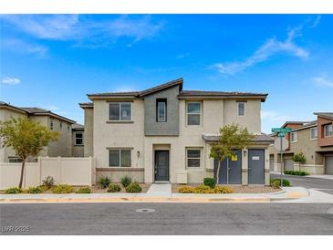 Charming two-story home featuring stylish stucco and gray accents, and a well-maintained landscaped yard at 12107 Frost Lime Rd # 1, Las Vegas, NV 89183