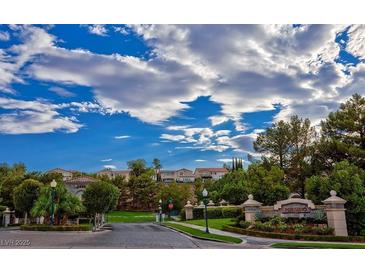 Community entrance with landscaped Presidio sign, trees and home roofs under cloudy blue sky at 1353 Volturno Way, Henderson, NV 89052