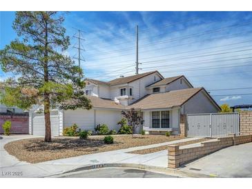 Charming two-story home featuring a well-manicured front yard and neutral color palette at 7726 Keating Cir, Las Vegas, NV 89147