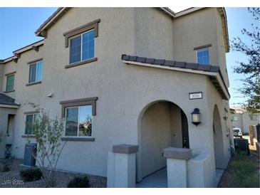 Charming two-story home featuring a welcoming arched entryway and neutral stucco finish at 806 Star Estates Ave, North Las Vegas, NV 89086