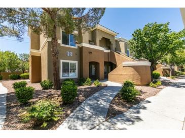 Inviting two-story condo building with mature trees and well-maintained landscaping at 8070 W Russell Rd # 2121, Las Vegas, NV 89113