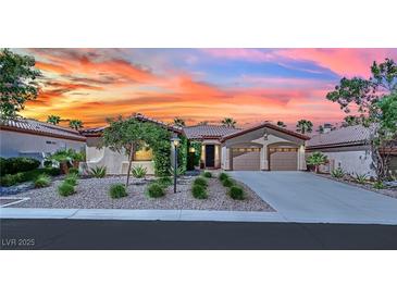 Charming single-story home with a well-manicured yard and two-car garage, enhanced by a colorful sunset backdrop at 8134 Maddingley Ave, Las Vegas, NV 89117