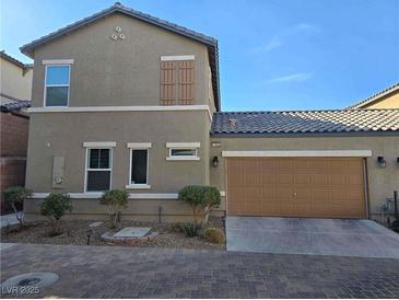 Charming two-story home featuring a two-car garage and a well-maintained front yard at 1050 Spotted Saddle St, Henderson, NV 89015