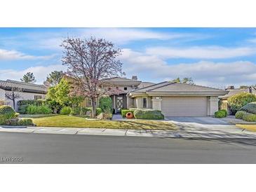 Charming single-story home with manicured lawn, mature trees, and attached garage at 11 Feather Sound Dr, Henderson, NV 89052