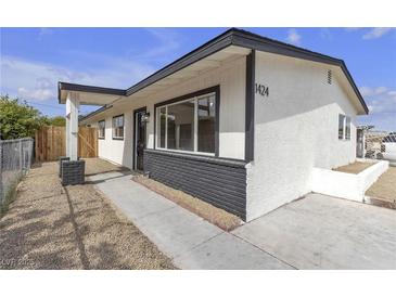 Charming single-story home featuring a freshly painted exterior and well-maintained landscaping, creating an inviting curb appeal at 1424 Balzar Ave, Las Vegas, NV 89106