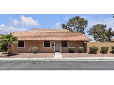 Charming single-story home featuring a traditional red tile roof, desert landscaping, and a well-maintained exterior at 2504 Paradise Village Way, Las Vegas, NV 89120