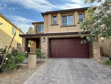 Charming two-story home with brick accents, a wide driveway, and an attached two-car garage at 2947 Caxton Grove Dr, Henderson, NV 89052