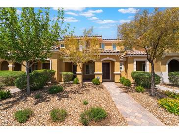 Charming townhome featuring a well-maintained front yard with desert landscaping and a welcoming walkway at 3088 Bicentennial Pkwy, Henderson, NV 89044