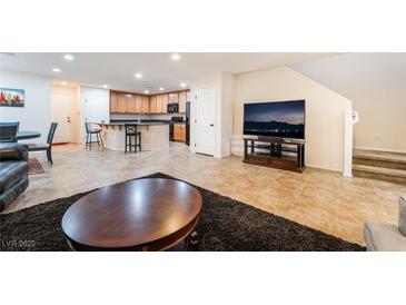 Open-concept living area with a kitchen island, tile floors, and a seamless flow for entertaining at 3088 Bicentennial Pkwy, Henderson, NV 89044