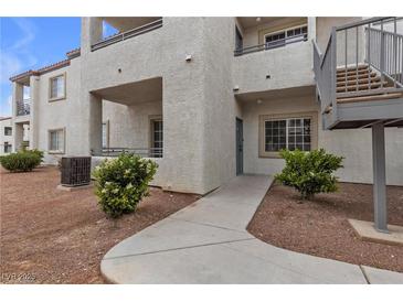 Beige two story condo with staircase, walkway and desert landscaping at 3318 N Decatur Blvd # 1043, Las Vegas, NV 89130