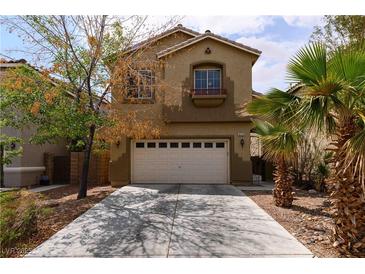 Charming two-story home with a two car garage and desert landscaping at 6279 Dollar Bill Ct, Las Vegas, NV 89141