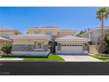 Stunning two-story home with a tile roof, stone accents, an attached three-car garage, and a well-manicured lawn at 712 Proud Eagle Ln, Las Vegas, NV 89144