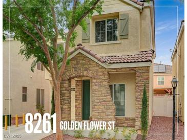 Charming two-story home features a stone facade, tiled roof, and well-maintained landscaping at 8261 Golden Flowers St, Las Vegas, NV 89139